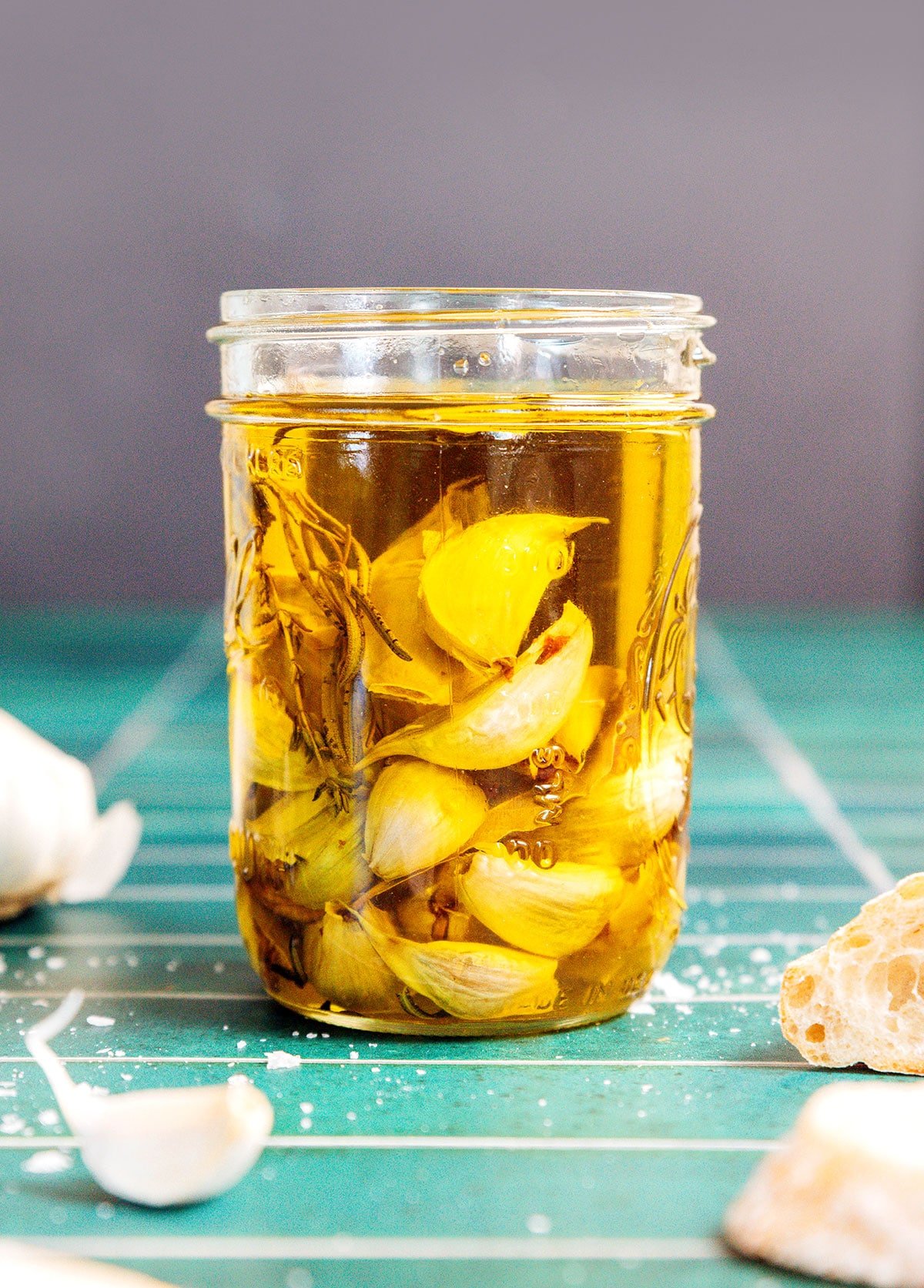 A mason jar filled with garlic cloves in olive oil