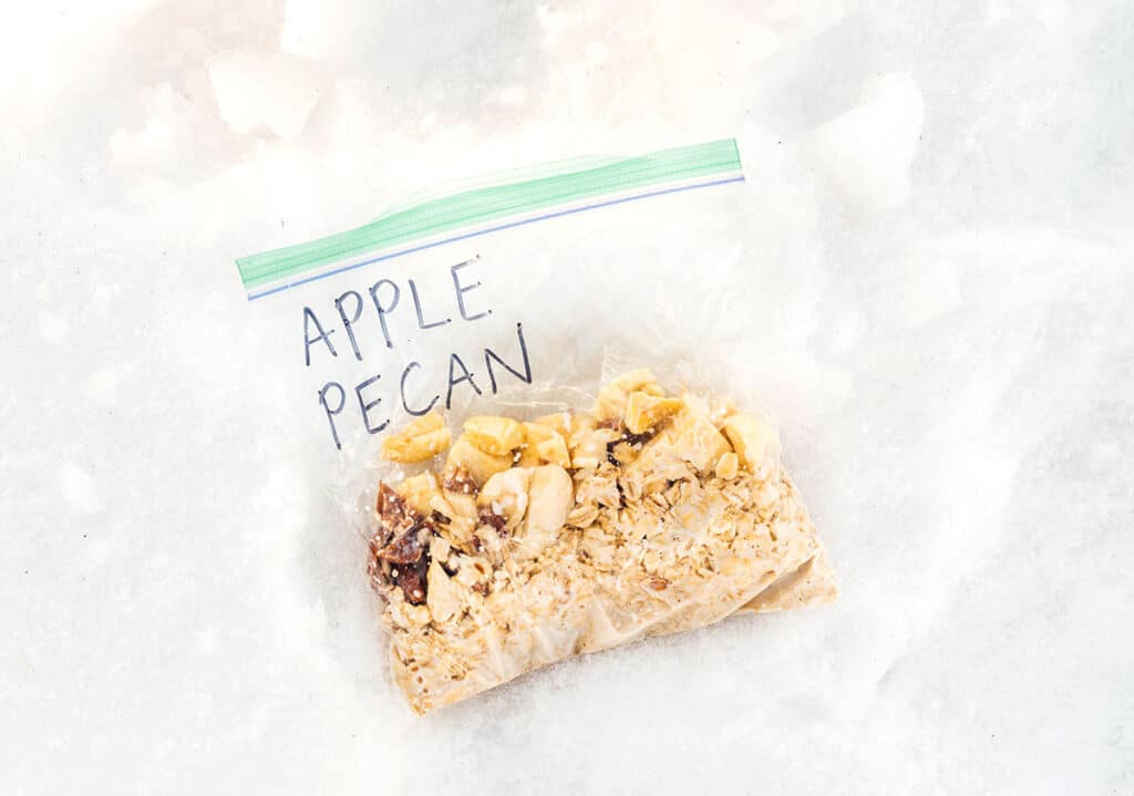An on-the-go oatmeal pouch filled with rolled oats, milk, chopped pecans, and dried apples