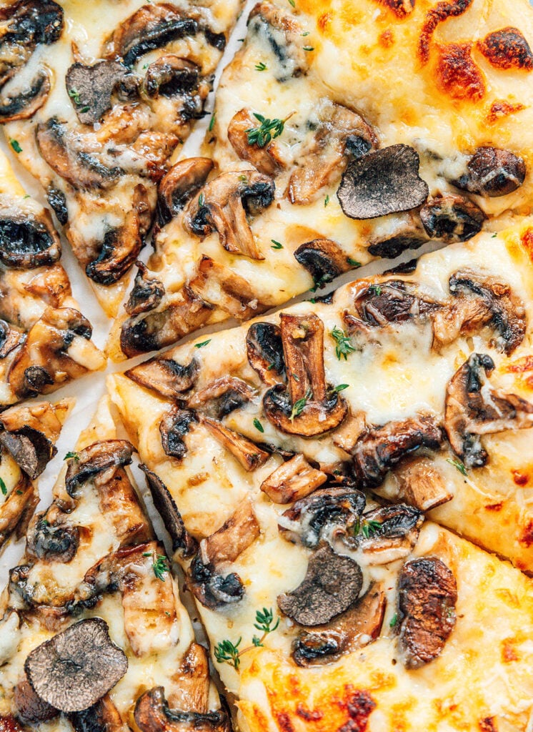 A close up view detailing the texture and toppings on truffle pizza