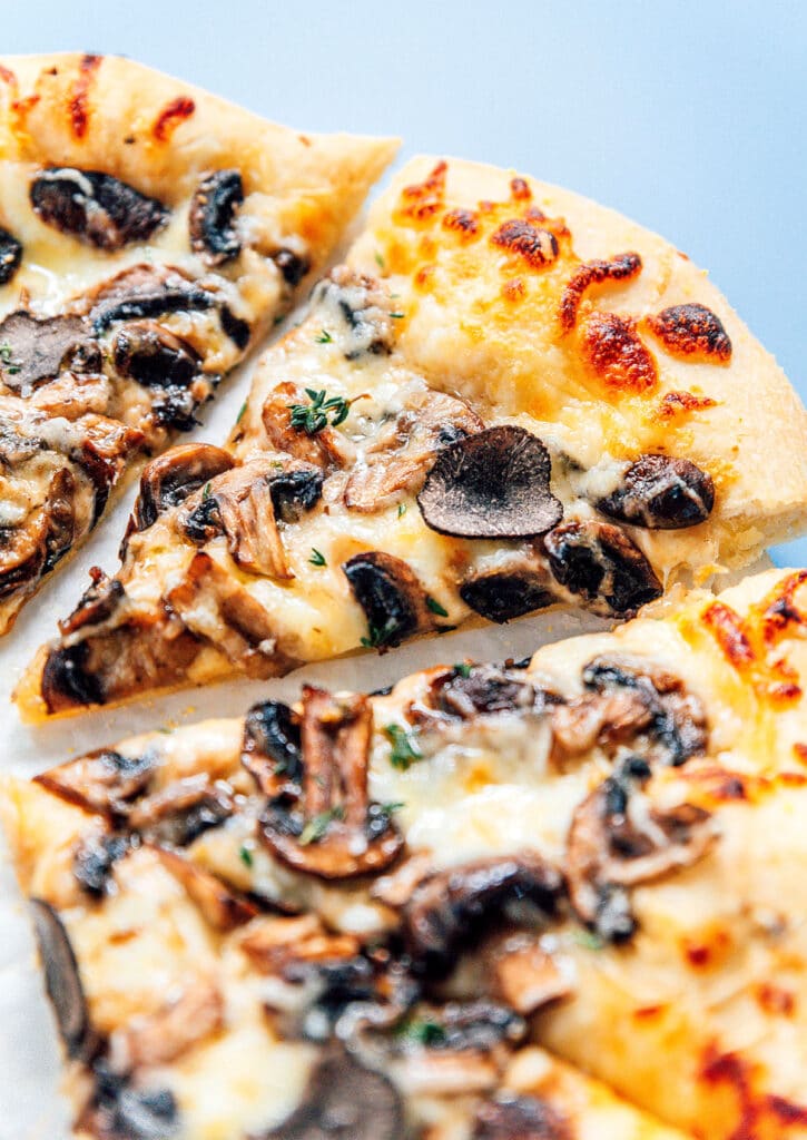 Fresh truffle pizza topped with mushrooms, herbs, and truffles