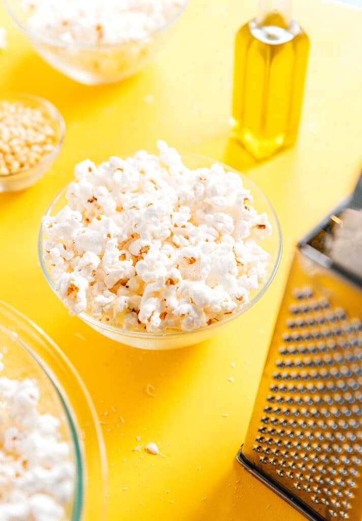 A clear glass bowl filled with easy truffle popcorn