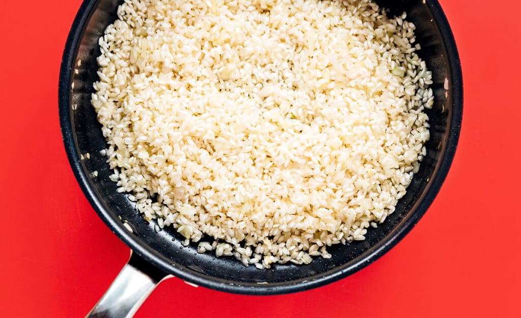 A pan filled with uncooked arborio rice