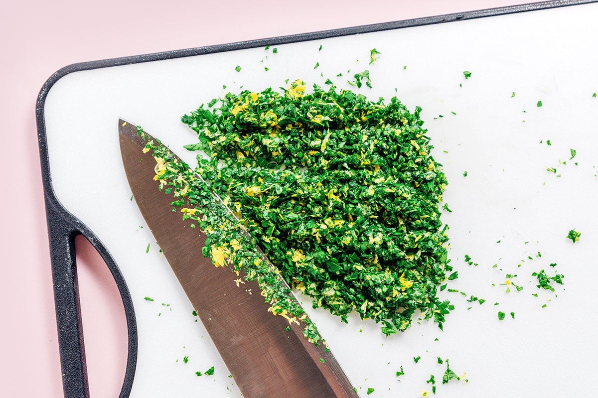 A cutting board topped with a pile of gremolata