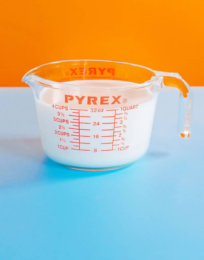 A measuring cup filled with 1 quart of milk