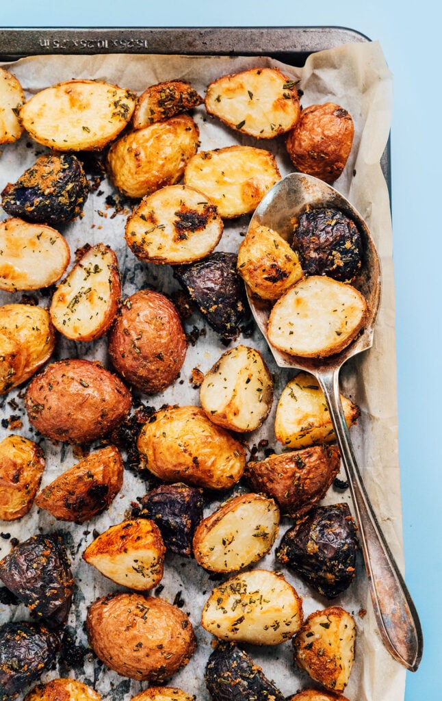 A baking sheet filled with a single layer of rosemary roasted potatoes