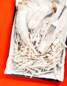 Shredded king mushroom on a baking tray.