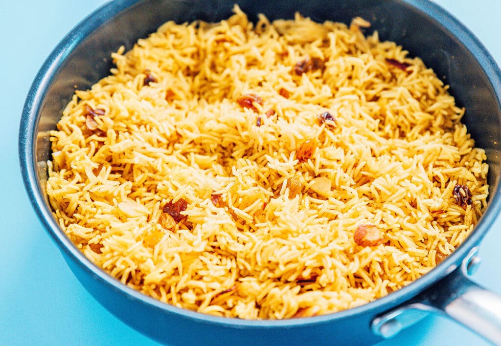 A skillet filled with freshly cooked and flavored basmati rice