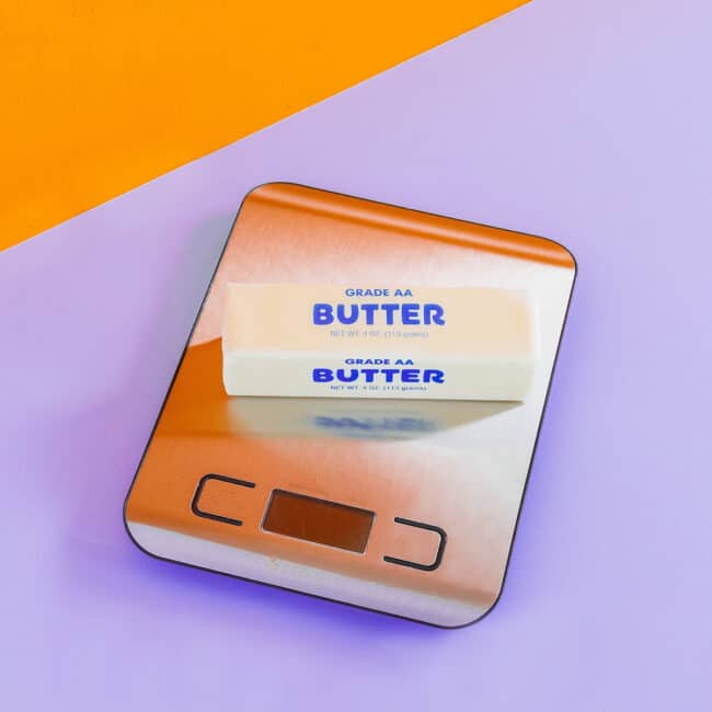 a scale with a stick of butter on it