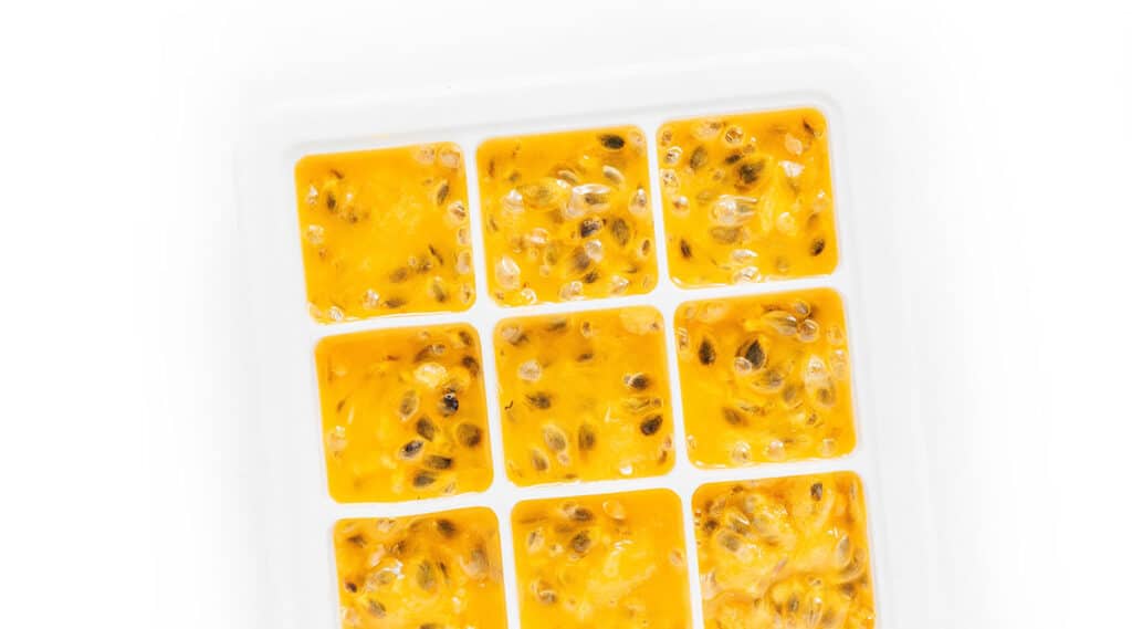 Ice tray filled with passion fruit puree before freezing.
