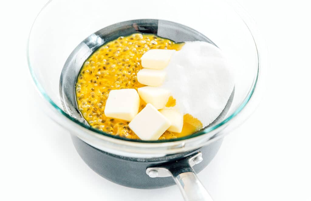 Passion fruit puree, butter, and sugar in a double boiler.