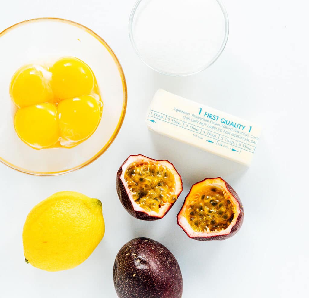 Ingredients for passion fruit curd on a white background