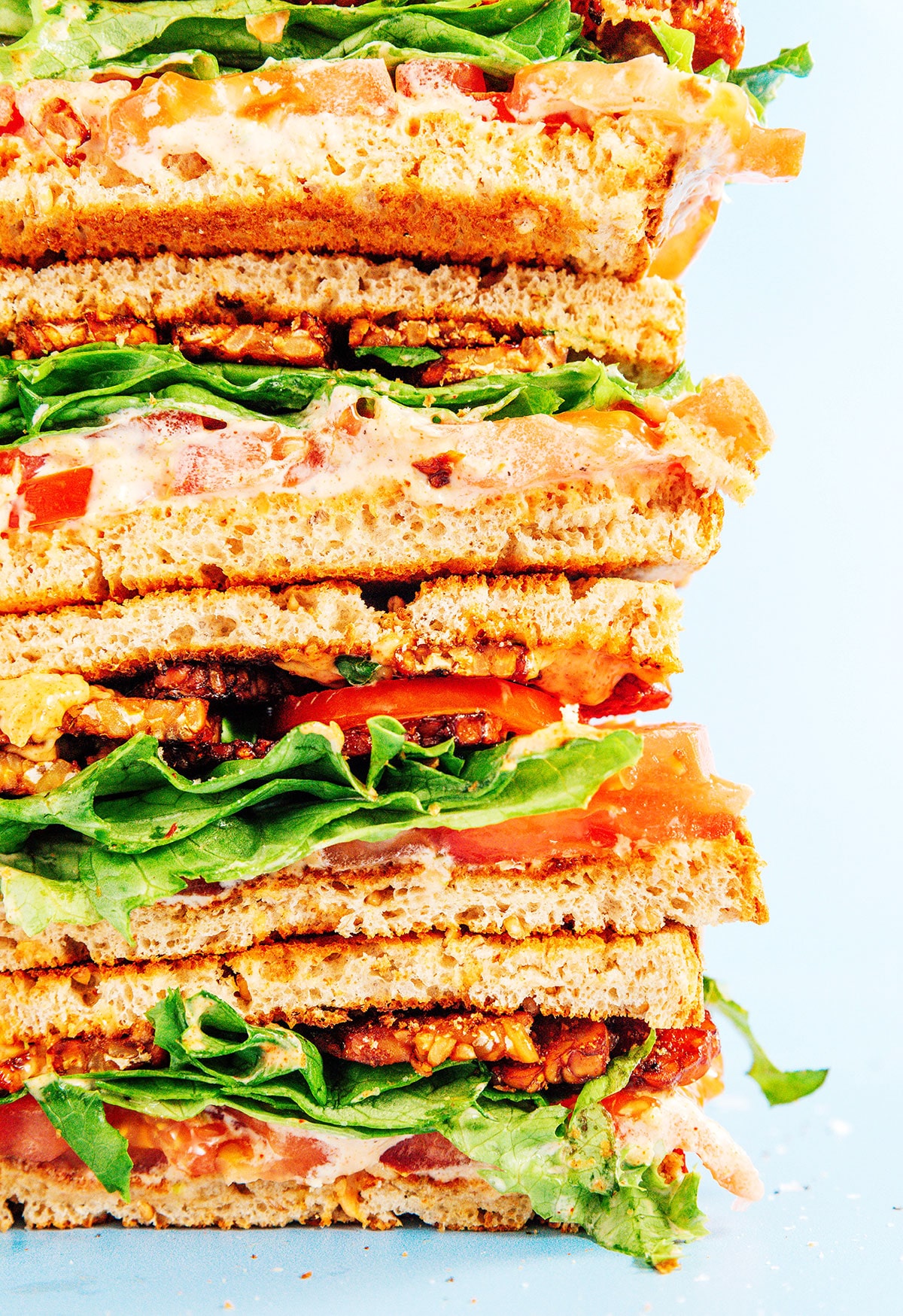 Tempeh bacon BLT sandwiches in a stack.