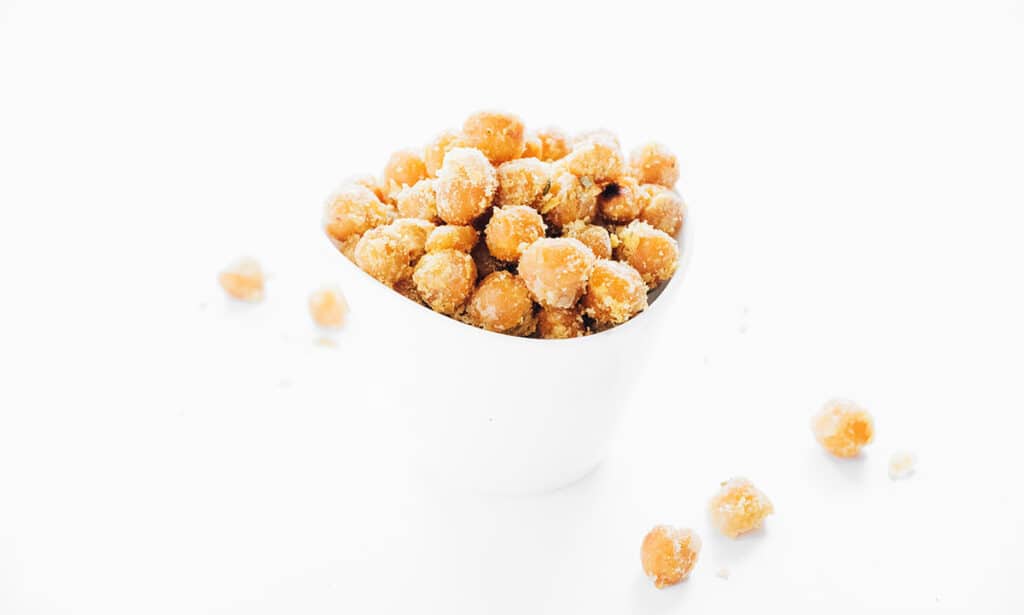 Closeup of chickpeas in a white bowl.