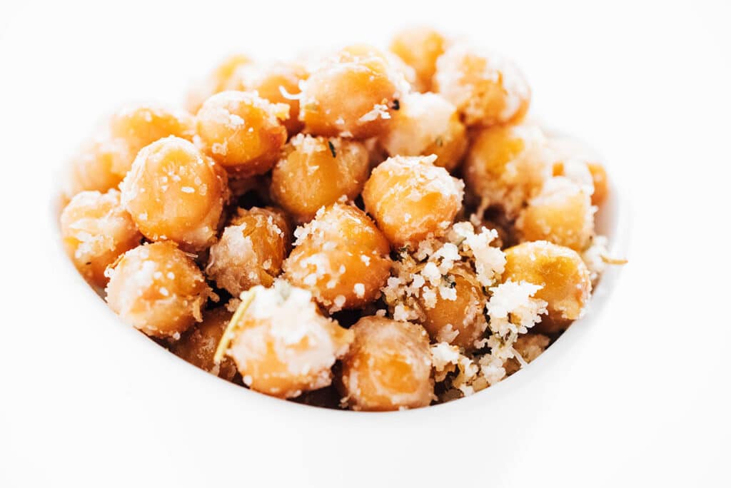 Closeup of chickpeas in a white bowl.