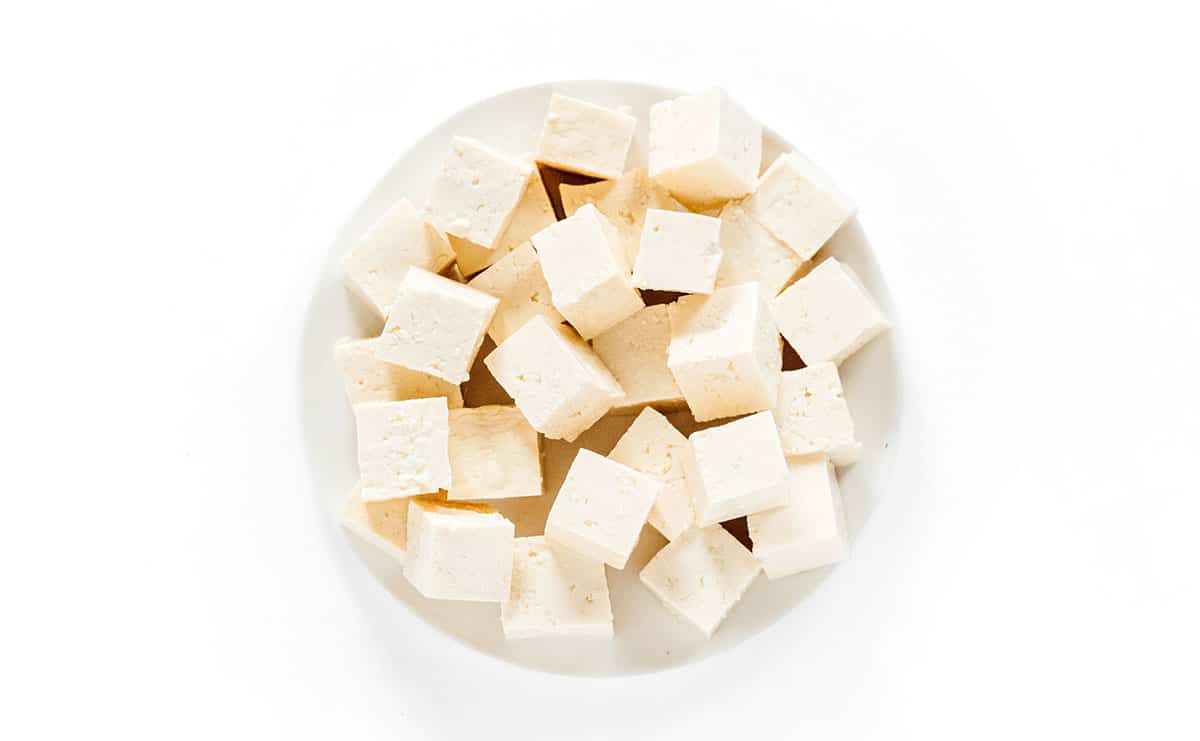 Plain tofu cubes in a white bowl.