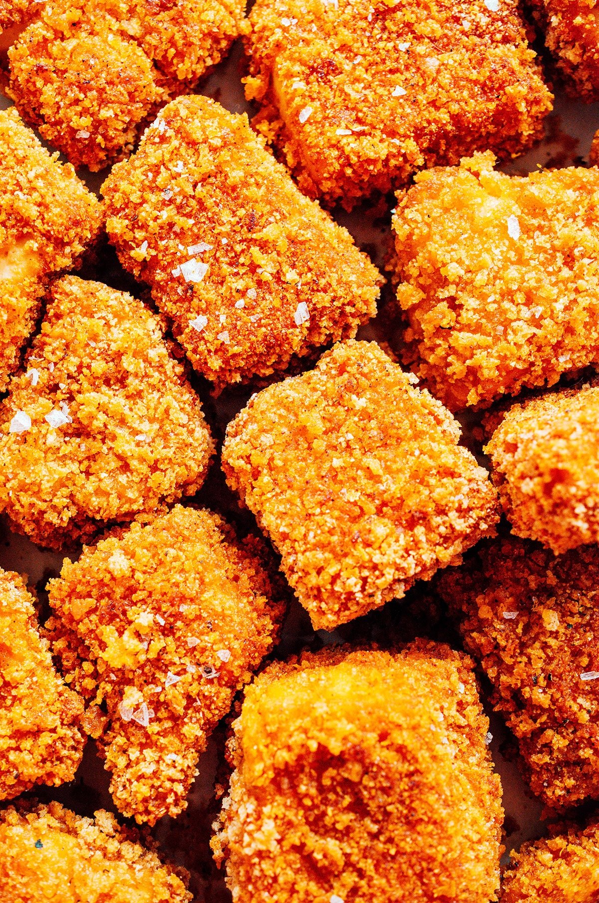 Closeup of the texture of breaded tofu nuggets.
