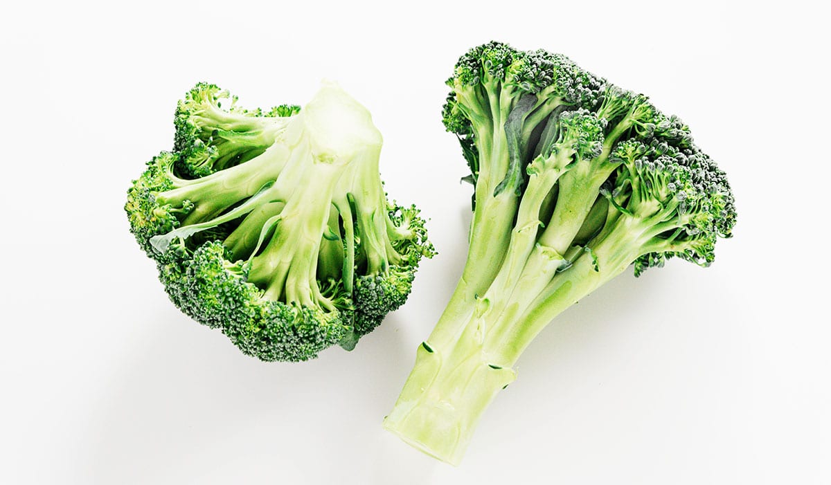 2 heads of broccoli on a white background