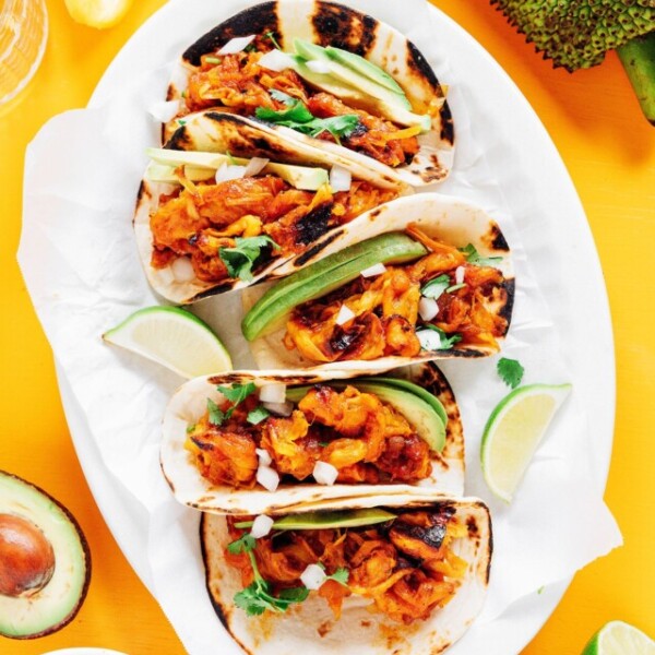 Tacos with jackfruit carnitas on a white platter