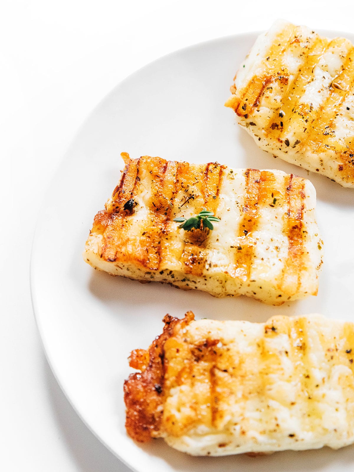 Grilled halloumi cheese on a white plate