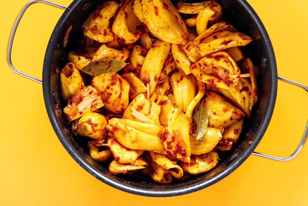 Jackfruit and spices mixed together in a large pot.