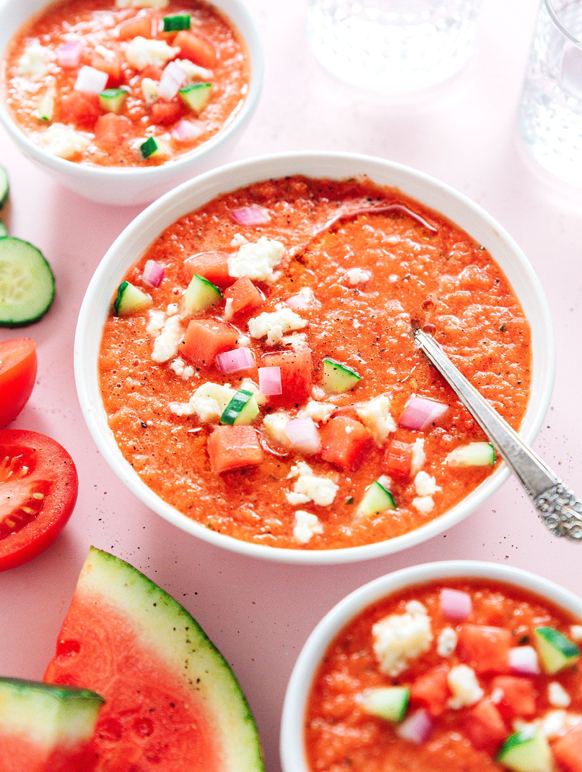 Top view of a bowl of watermelon tomato soup topped with feta.