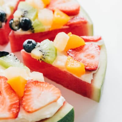 A slice of watermelon pizza with fruit on top