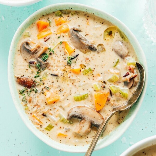 Wild rice soup in a bowl with a spoon.