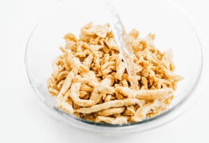 Soaking soy curls in glass bowl of water.