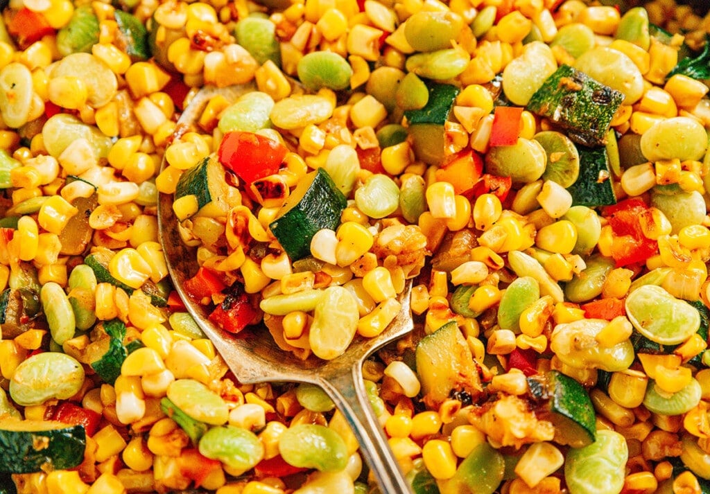Succotash up close showing the charred corn and zucchini.