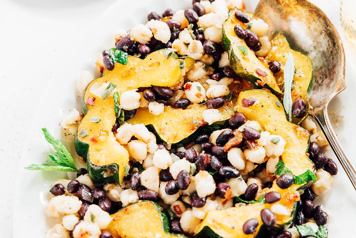 Platter with acorn squash, black beans, and hominy.