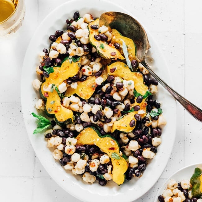 Platter with acorn squash, black beans, and hominy.