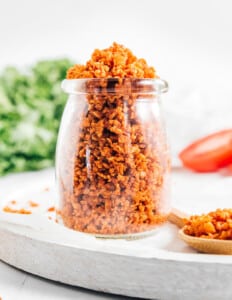 Vegan bacon bits in a glass jar on a white background
