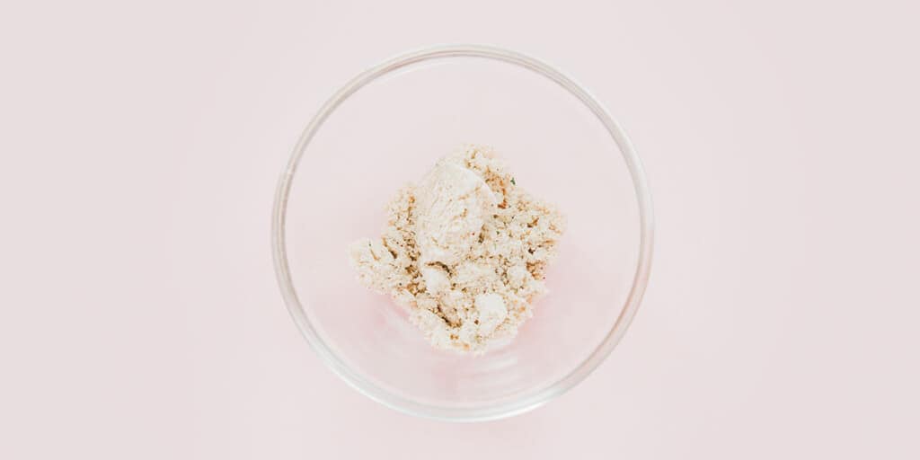 Vegan pork flavored broth base powder in a small glass bowl.