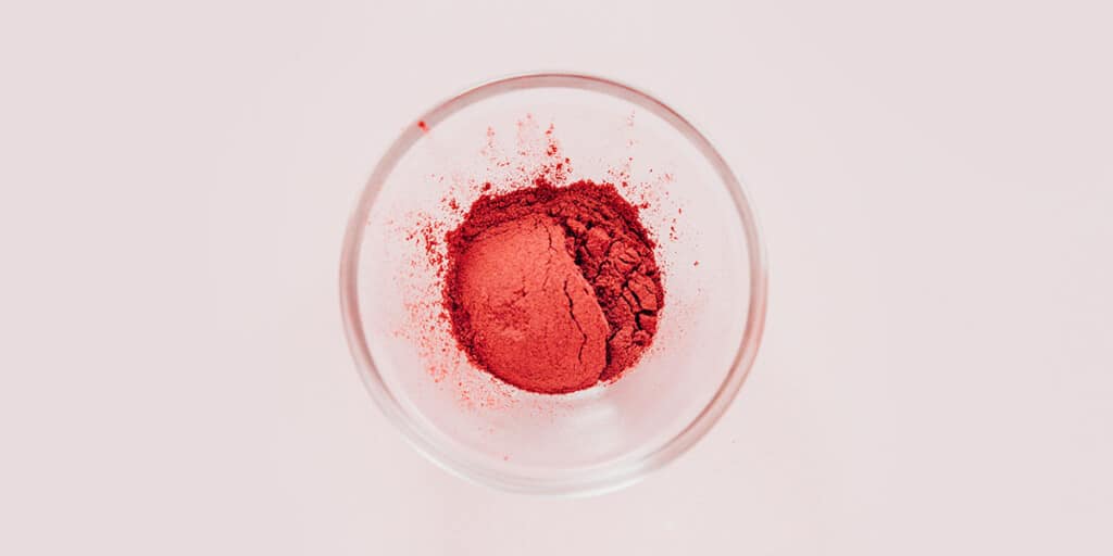 A small glass bowl with beet powder.