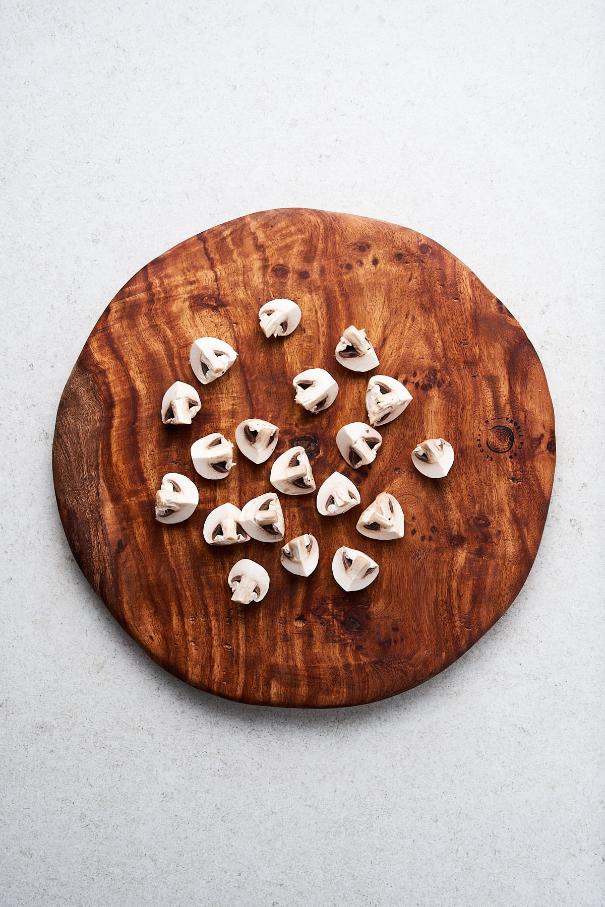 Quartering mushrooms on a cutting board