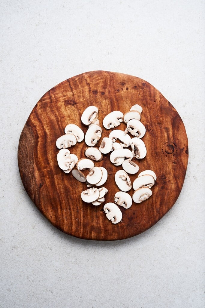Sliced mushrooms on a cutting board