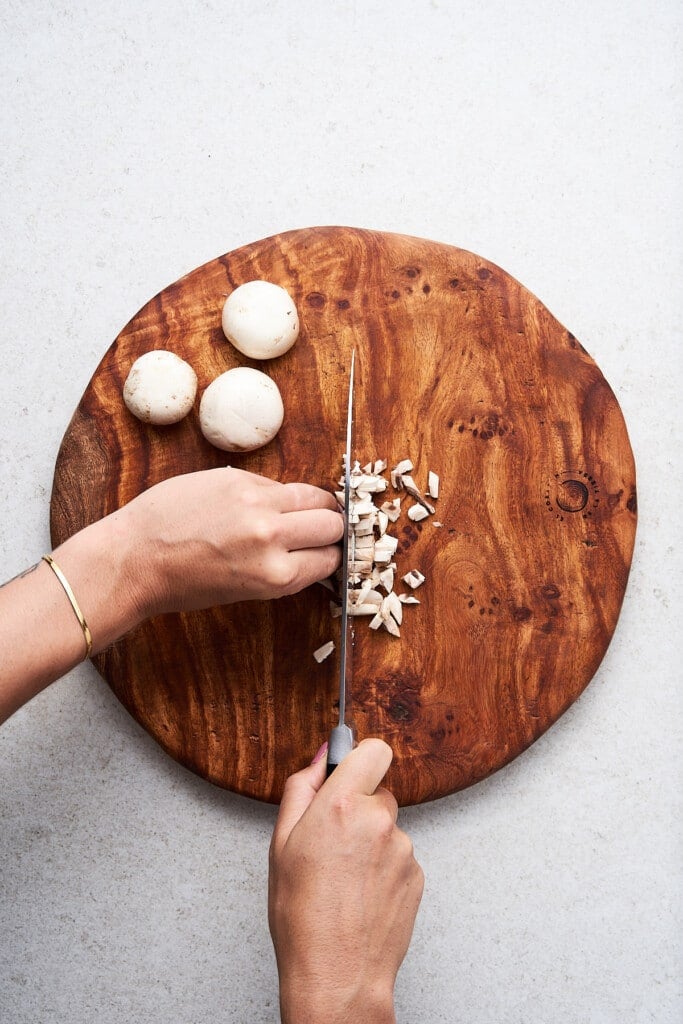 Dicing mushrooms on a cutting board