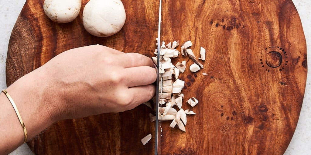 Option 4 - Diced: Start by slicing the mushroom as laid out in option 2. Without moving the sliced mushroom, cut it into matchsticks. Rotate your cutting board or knife 90 degrees, then dice the mushroom matchsticks into small pieces.