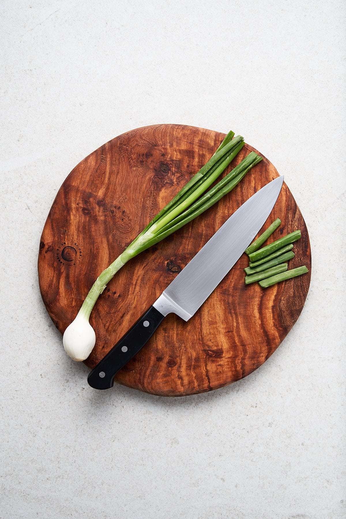 Trimmed green onions on a cutting block