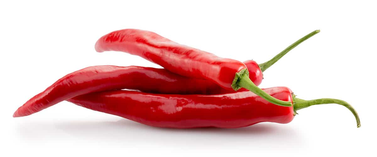 Cayenne peppers on white isolated background.
