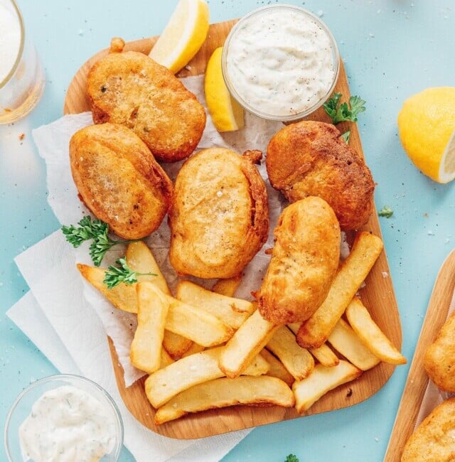 Vegan fish and chips on a square plate with fries