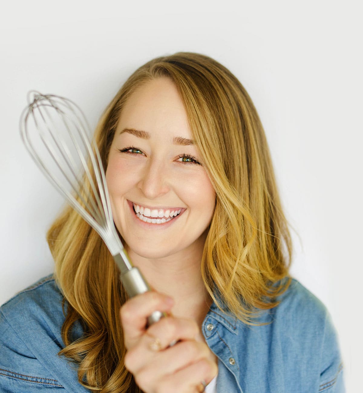 Sarah Bond of Live Eat Learn with whisk.