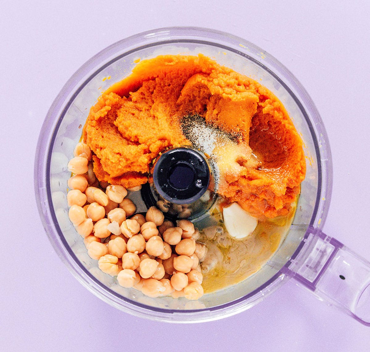 Pumpkin puree, chickpeas, and other ingredients in a food processor to make hummus.
