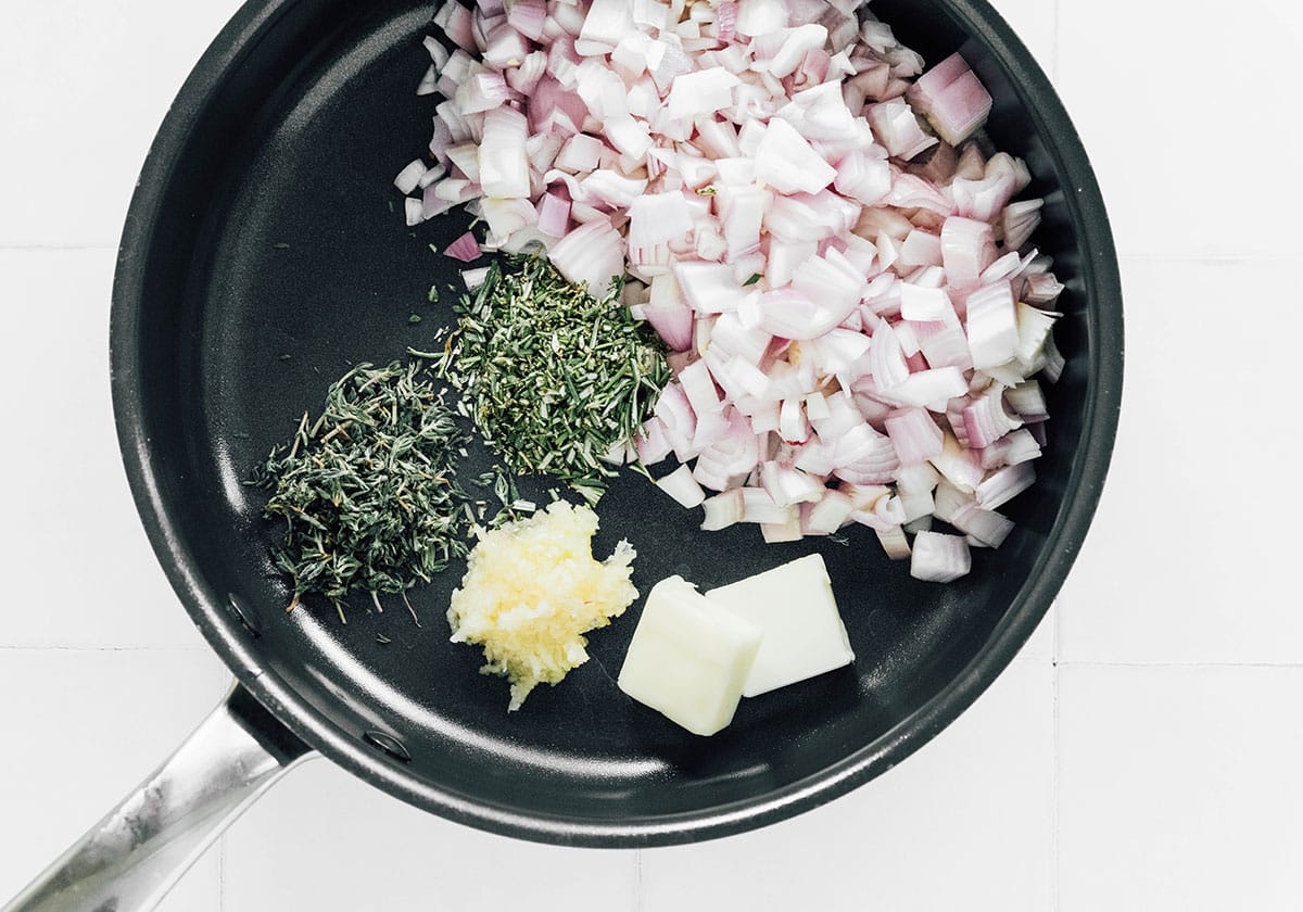 Onions, garlic, herbs, and butter in a saucepan.
