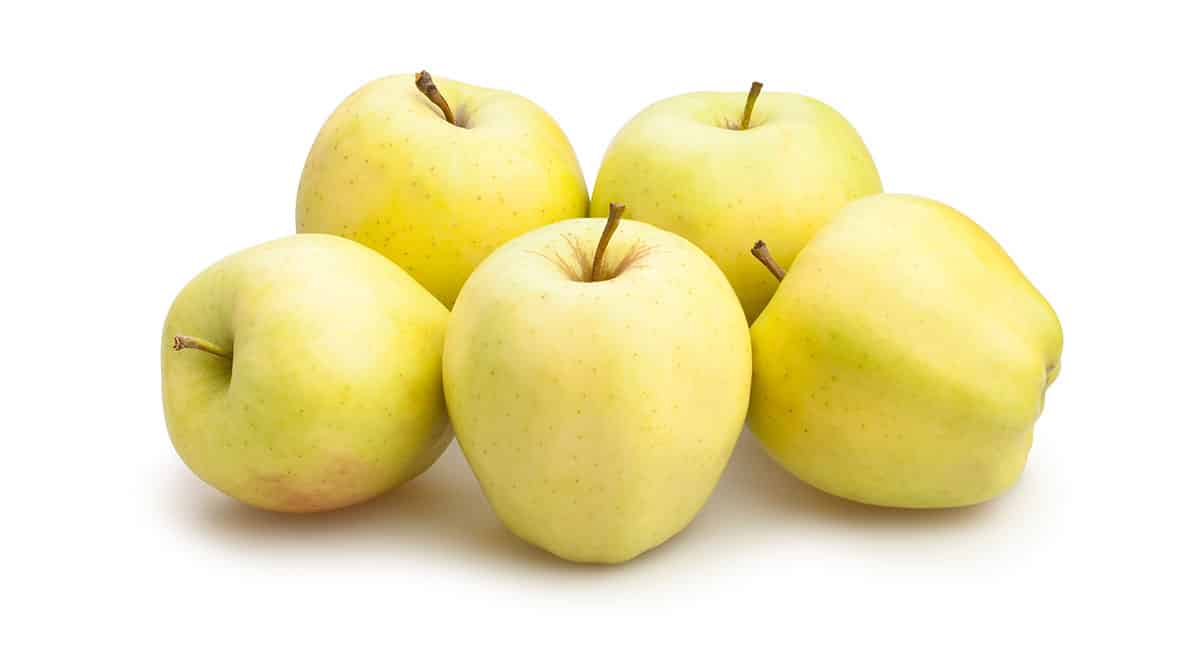 Golden apples on white background.