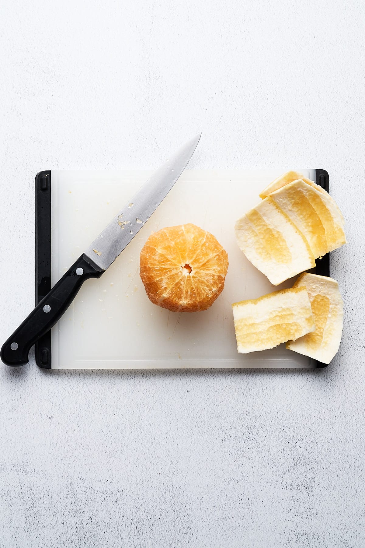 Supremed orange on a cutting board.