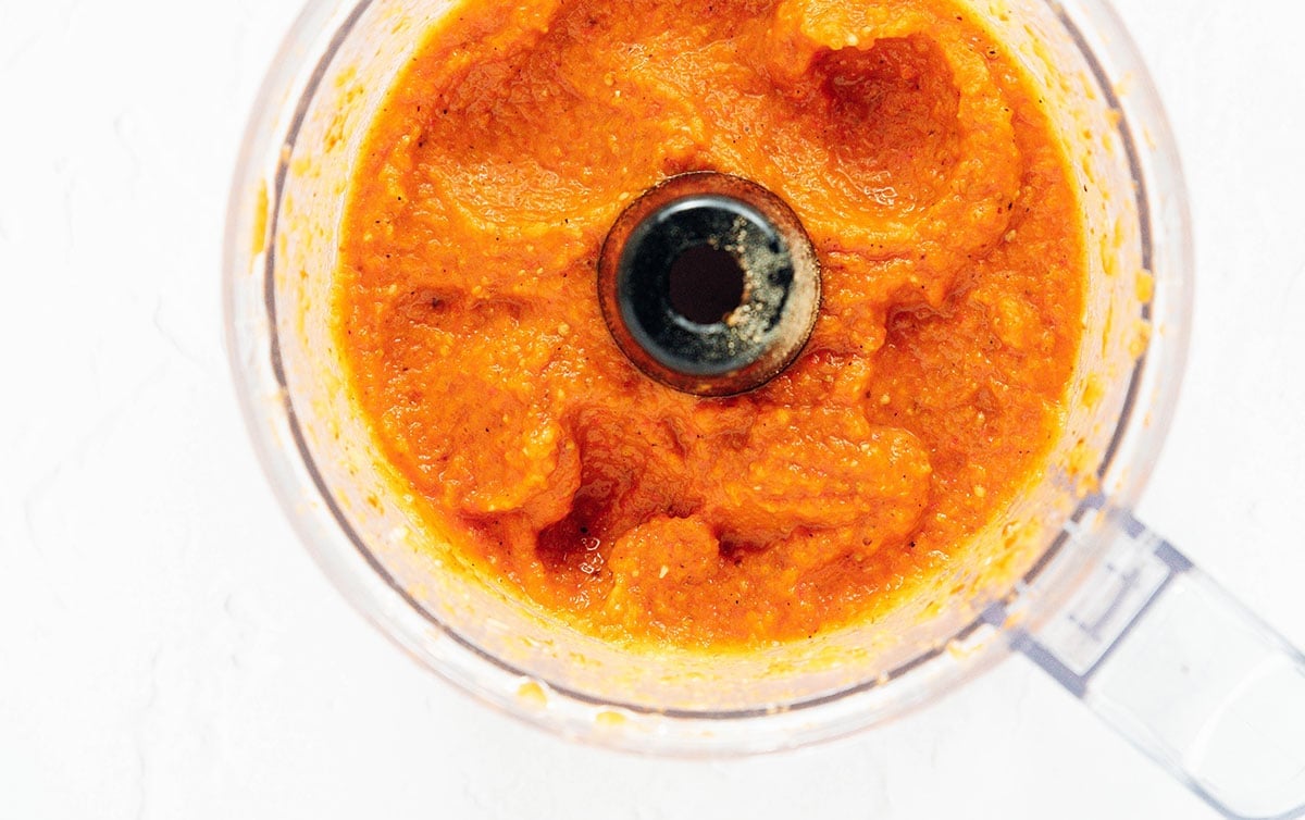 Smooth ajvar sauce in the bowl of a food processor.
