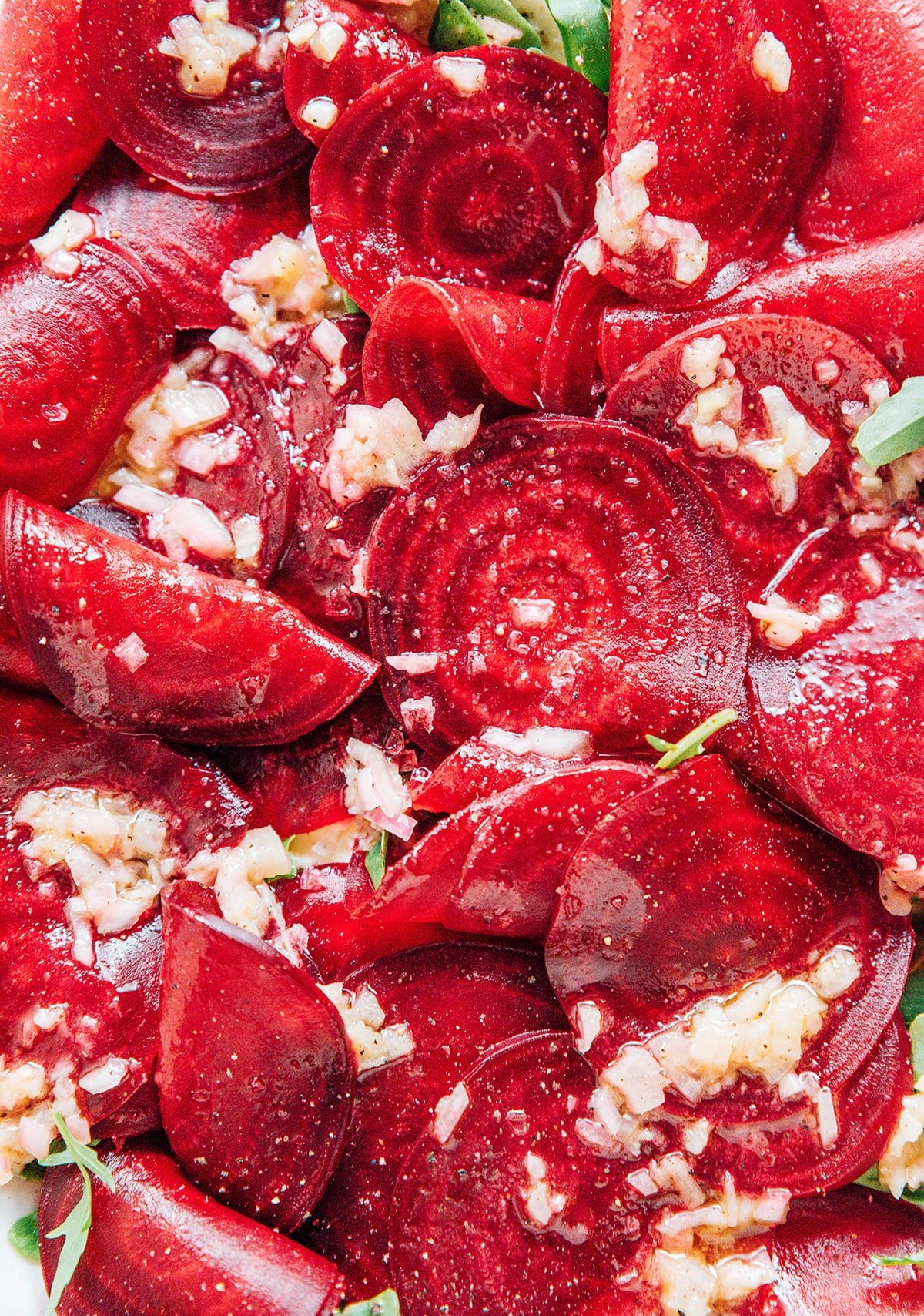 Close up image of bright red beet slices in the carpaccio.