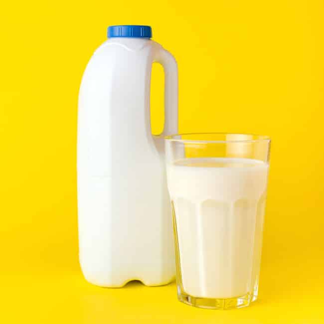 Quart of milk on a yellow background