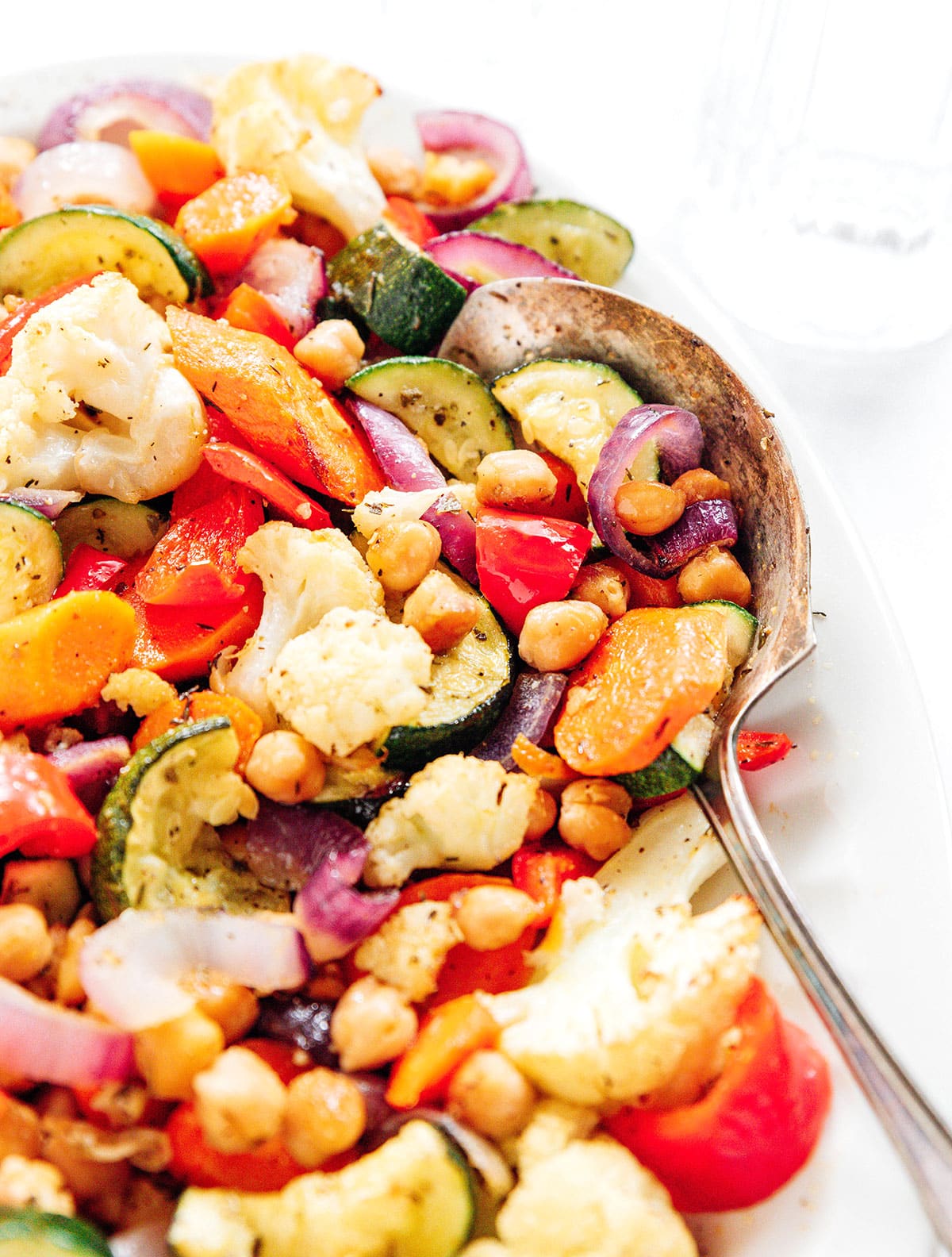 Roasted veggies with Mediterranean seasoning in a serving bowl.